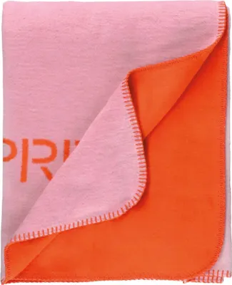 A folded blanket with two different colored sides.