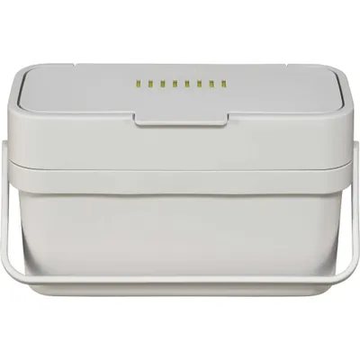 A white compost bin with a handle and a lid with indicator lights.