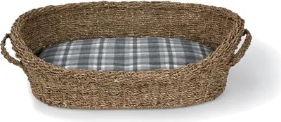 A pet bed with a woven basket exterior and a plaid cushion.