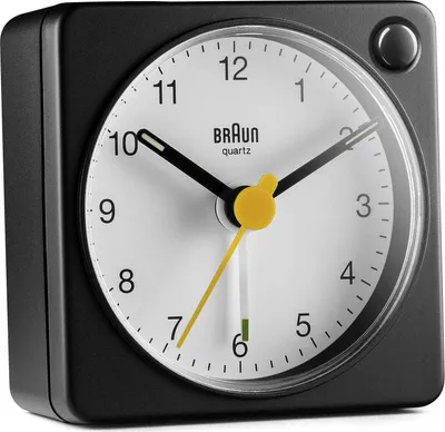 A close-up, studio shot of a black Braun alarm clock with a white face.