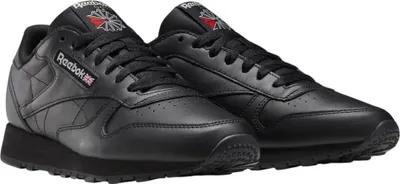 A pair of black Reebok Classic Leather sneakers.