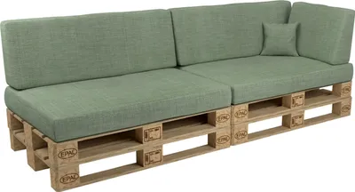 A sectional sofa made from wooden pallets with green cushions.