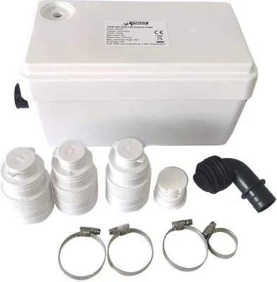 A white wastewater pump with accessories laid out in front of it.