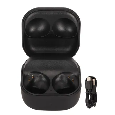 A black charging case for wireless earbuds, shown open with a charging cable next to it.