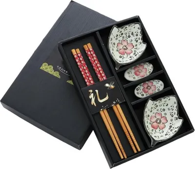 A gift set of sushi dishes and chopsticks in a black box.