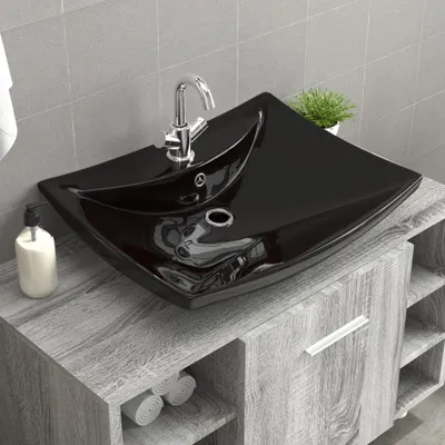 A black ceramic sink with a chrome faucet sits on a gray wood-grain vanity.