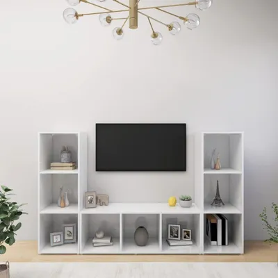 A TV stand with multiple shelves and a TV mounted above it.
