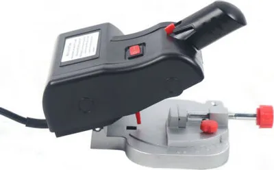 A close-up studio shot of a mini miter saw against a white background.