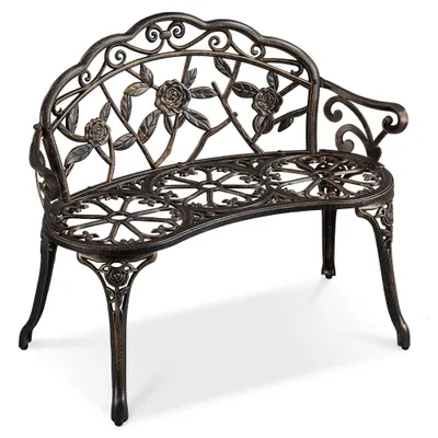 A studio shot of a vintage-style metal garden bench with a rose pattern.