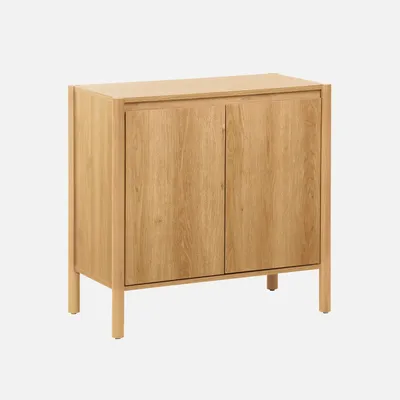 A wooden sideboard with two doors and four legs, presented against a plain gray background.