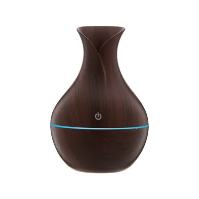 A brown aroma diffuser with a blue light ring and a power button symbol.