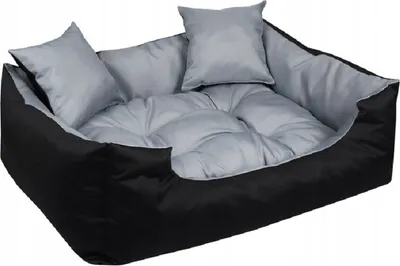A dog bed with two pillows inside, shown from a slightly elevated angle.