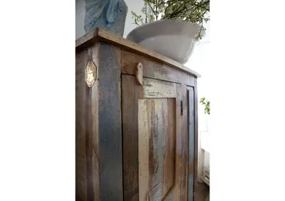 A close-up view of a rustic, multi-colored wooden cabinet.