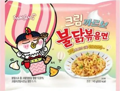 The image shows the packaging of Samyang Buldak Cream Carbonara noodles, featuring a cartoon character and a dish of the prepared noodles.