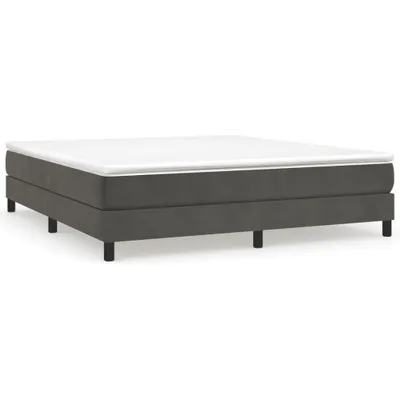 A dark gray boxspring bed frame with a white mattress on top, shown from a side-angle against a white background.