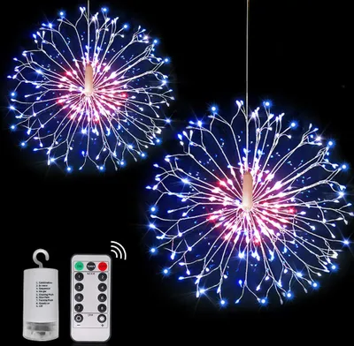 Two starburst-shaped LED lights hanging against a black background, with a battery pack and remote control shown in the lower left corner.