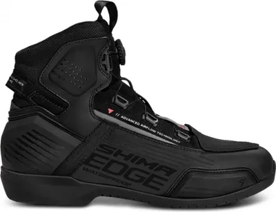 A black motorcycle boot is shown against a white background.
