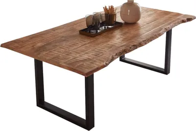 A wooden dining table with a live edge and black metal legs, set against a white background.