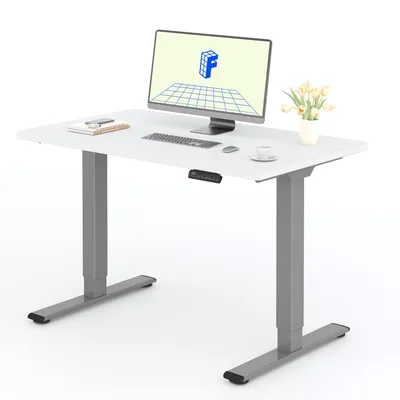 A white adjustable height desk with a computer, keyboard, mouse, coffee cup, and a vase of flowers.