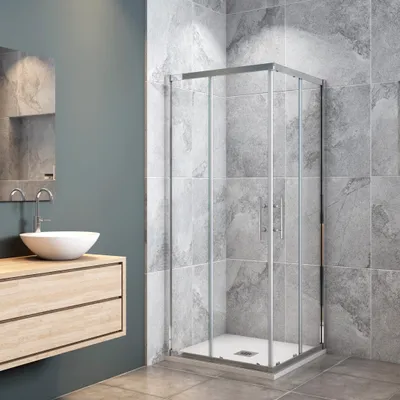 A modern bathroom with a shower cabin, sink, and vanity.