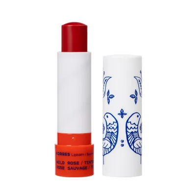 A lip balm and its cap are shown against a white background.
