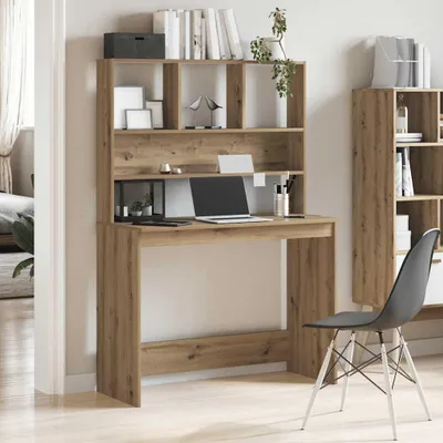 A home office setup with a wooden desk and shelves, a laptop, and a chair.