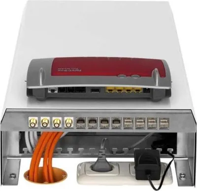 A multimedia box with a router on top and cables and an electrical outlet below.