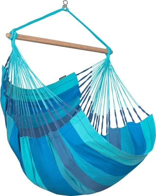A hanging chair made of fabric with blue and teal stripes, suspended from a wooden bar and a rope.