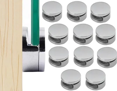 A collection of mirror clips and a wooden plank with a glass panel.