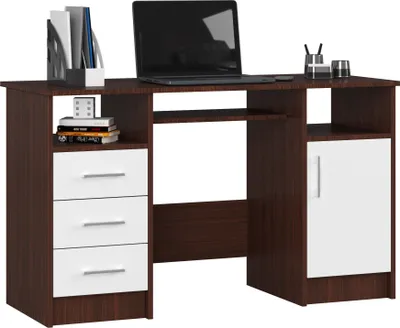 A studio shot of a modern PC desk with a laptop and office supplies.