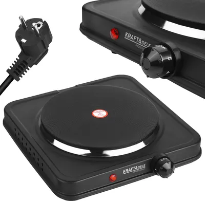 A close-up studio shot of a portable electric stove and its power plug.