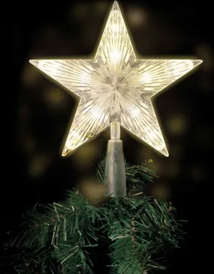 A star-shaped Christmas tree topper with LED lights sits atop a green Christmas tree.
