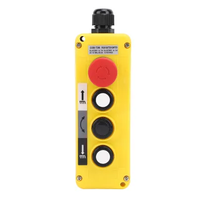 A yellow industrial pendant control station with buttons and symbols.