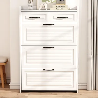 A white shoe cabinet with black handles is shown in a room with a wooden floor and a stool to the left.