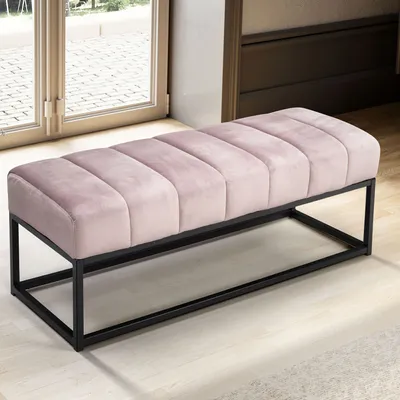 A pink upholstered bench with a black metal frame is shown in a room with a large window and light-colored flooring.