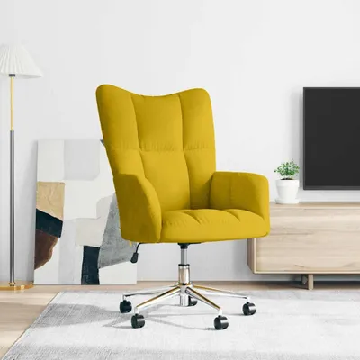 A yellow velvet armchair with a chrome base and wheels is shown in a living room setting, with a floor lamp and abstract art in the background.