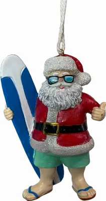 A Christmas ornament of Santa Claus dressed for the beach, holding a surfboard.