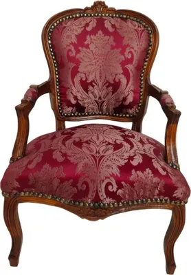 A close-up, front-facing studio shot of an antique armchair.
