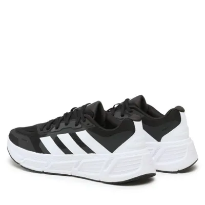 A pair of black and white Adidas running shoes.