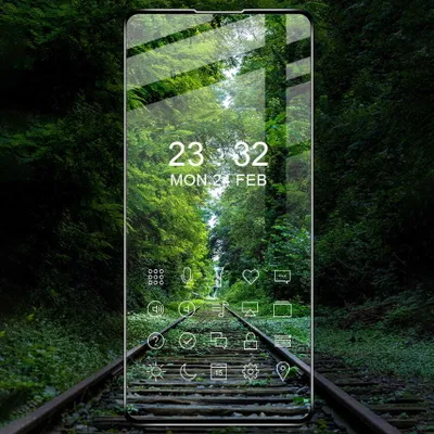 A smartphone screen displaying a nature-themed wallpaper with a train track leading into a forest. The screen shows the time and date, along with various app icons.