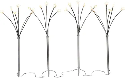 Four starburst-shaped LED light stakes on a white background.