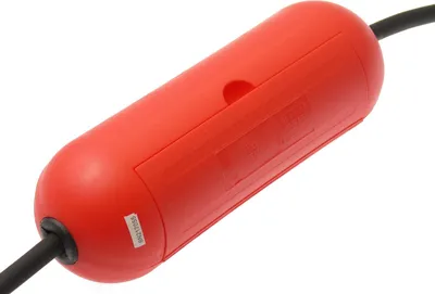 A close-up shot of a red safety box for an electrical plug, with a black cable entering from the left.