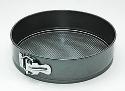 A round springform pan with a textured bottom and a silver latch on the side, set against a white background.