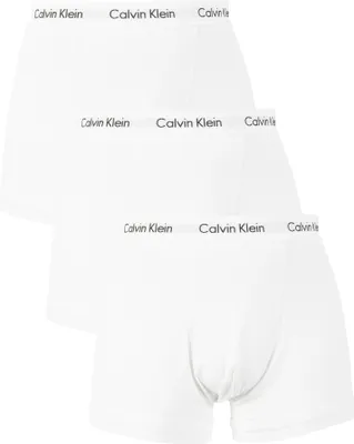 Three white Calvin Klein boxer briefs are stacked on top of each other.
