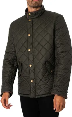 A man wearing a green quilted jacket.