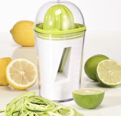 A juicer and spiralizer with lemons and limes.