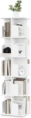 A white rotating bookshelf filled with books and decorative items.