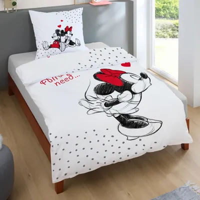 A bed with Mickey and Minnie Mouse themed bedding set.