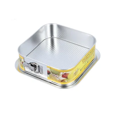 A square baking pan with a removable side and a patterned bottom, shown from a slightly elevated angle against a white background.