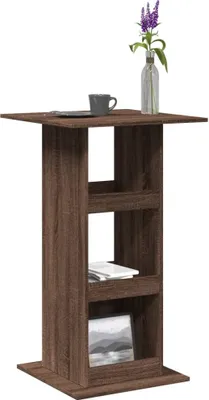 A tall, narrow bar table with three shelves, made of wood-look material, against a white background.